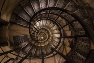 a spiral staircase in a building with metal railings