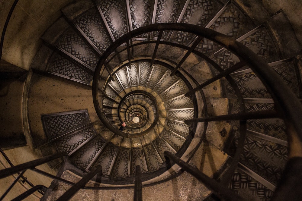 a spiral staircase in a building with metal railings