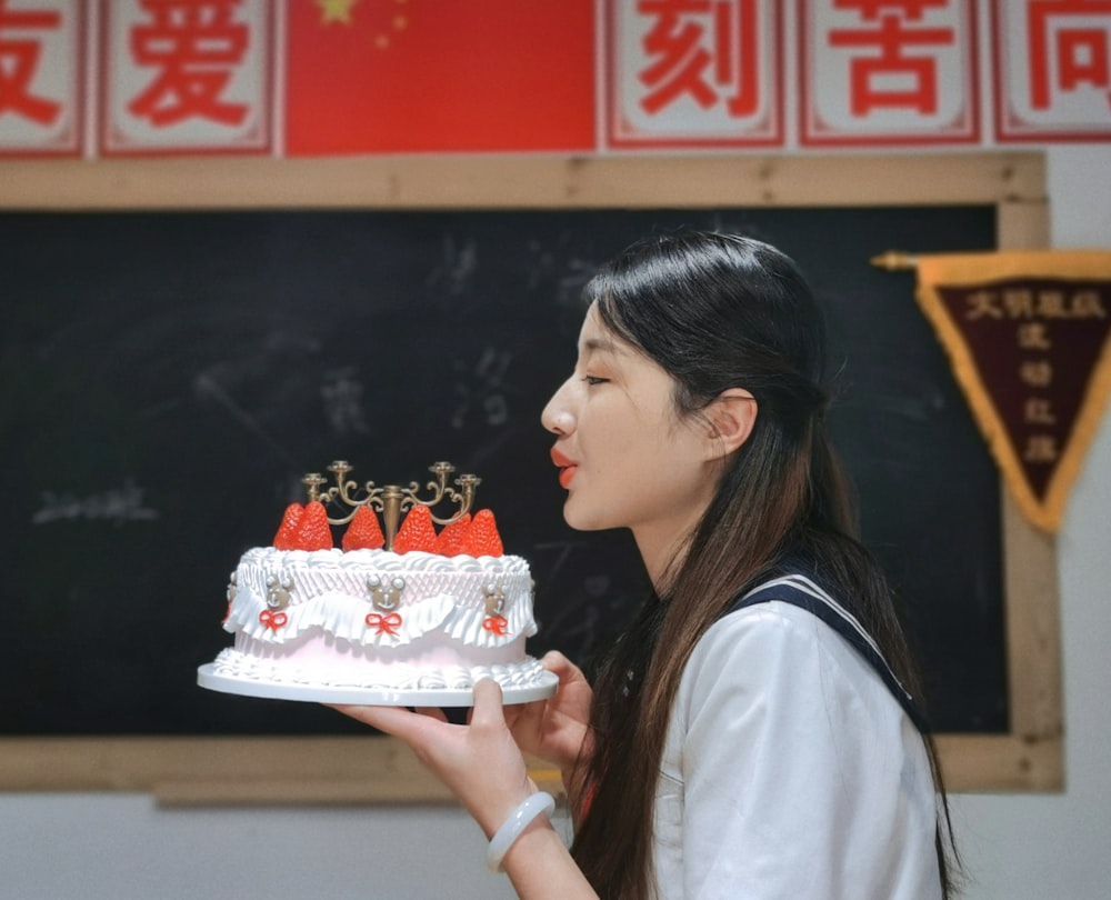 a woman holding a cake with candles on it