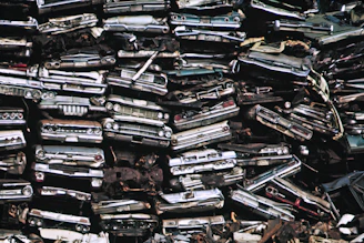 a pile of old cars sitting next to each other