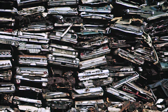 a pile of old cars sitting next to each other