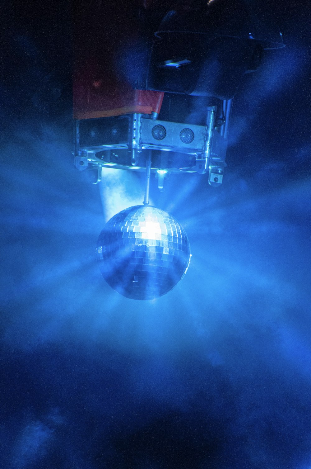 a disco ball hanging from the ceiling in a dark room