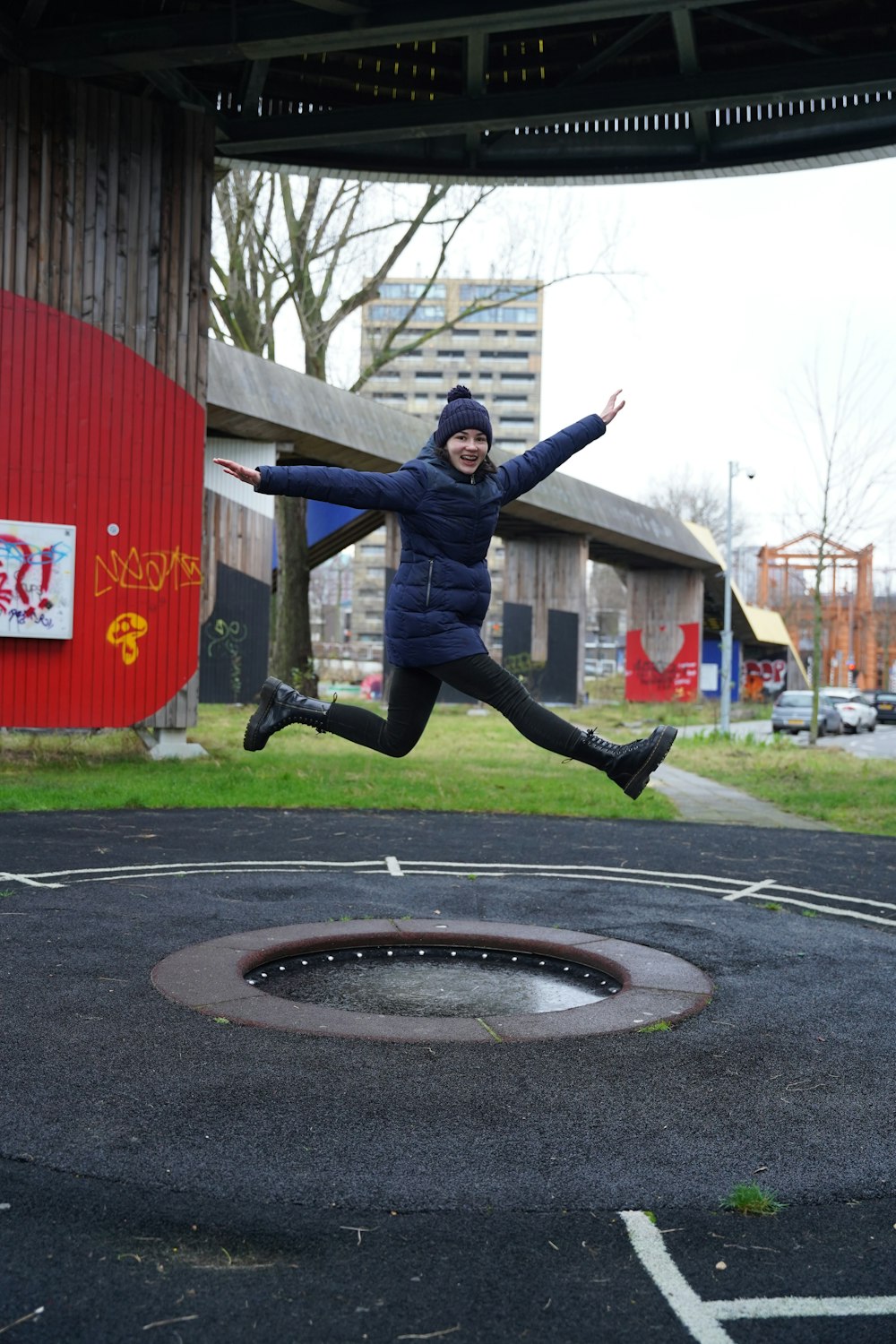 a person jumping in the air in a parking lot