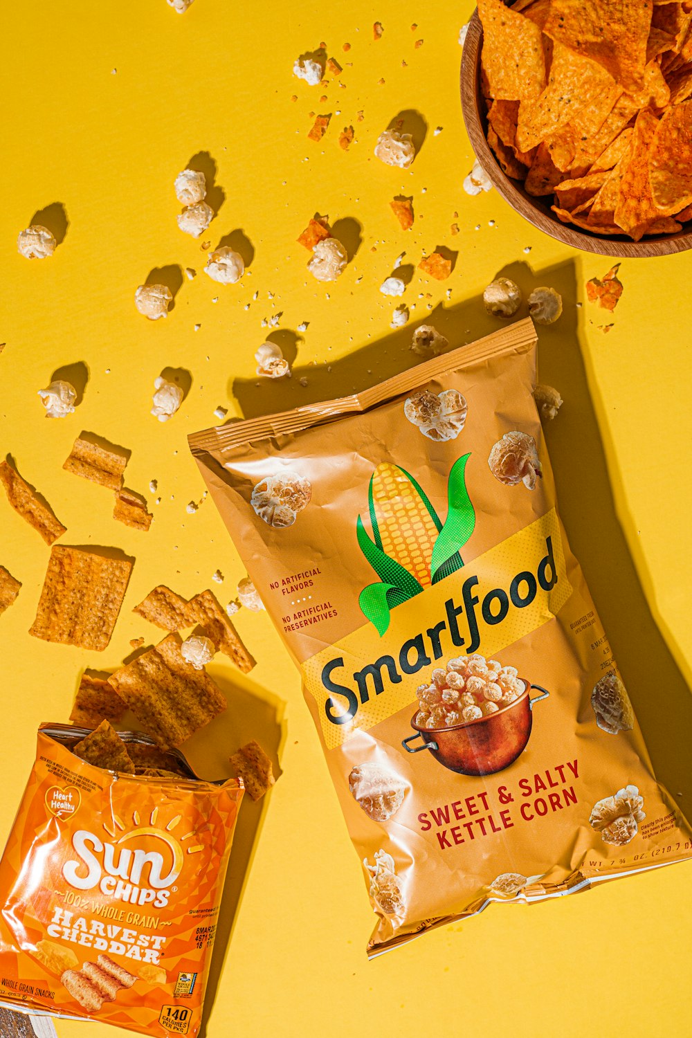 Una bolsa de SmartFood junto a un tazón de papas fritas