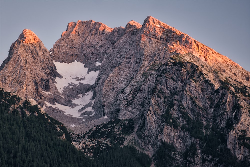 a mountain range with a snow covered peak