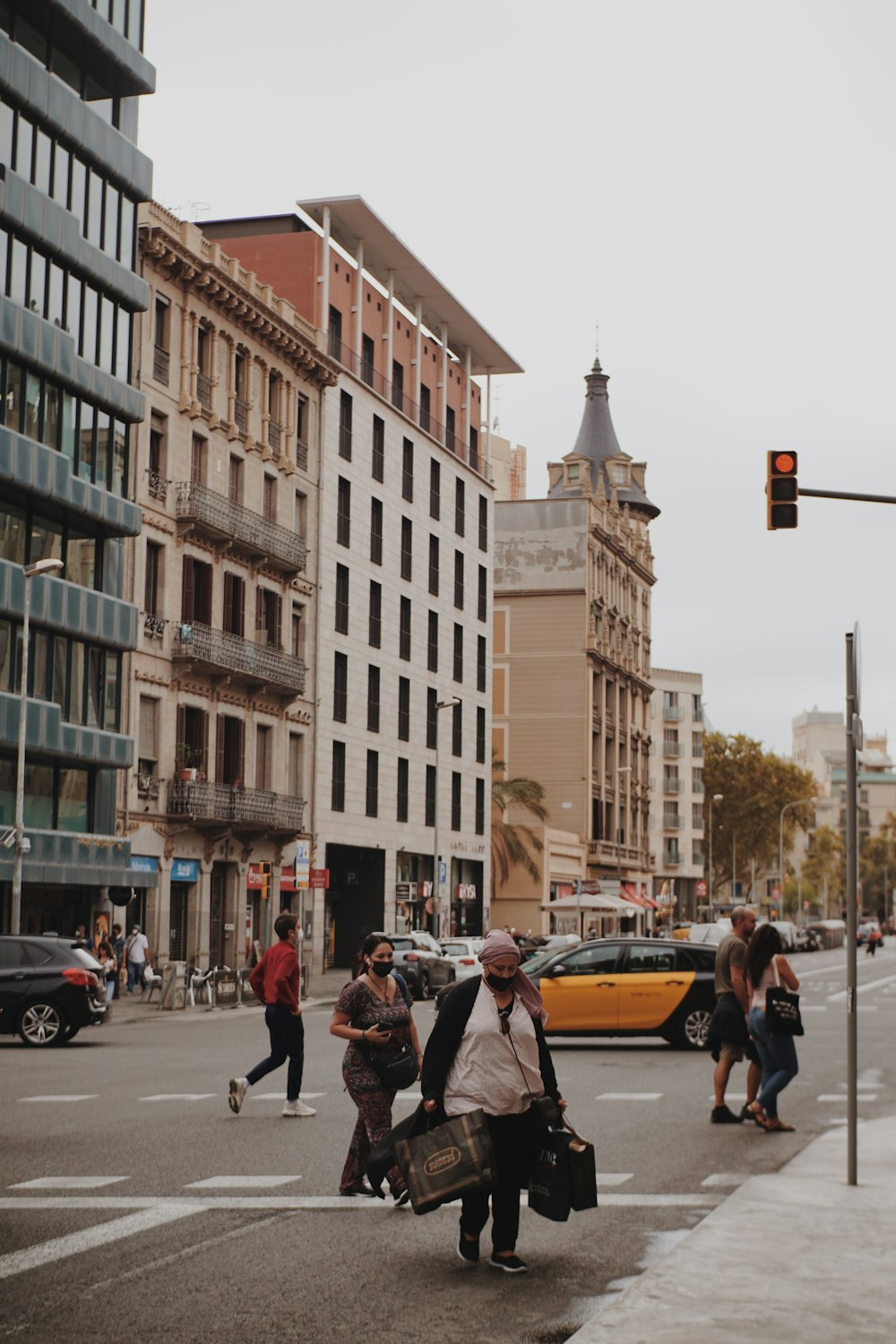 a group of people walking across a street