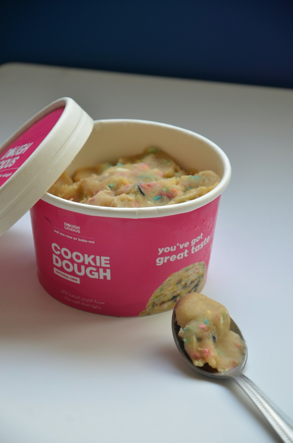 a bowl of cookie dough with a spoon next to it