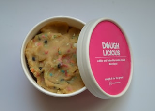 a cup of dough with sprinkles on it
