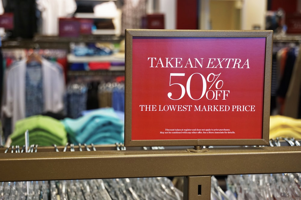 a sign that says take an extra 50 % off the lowest marked price