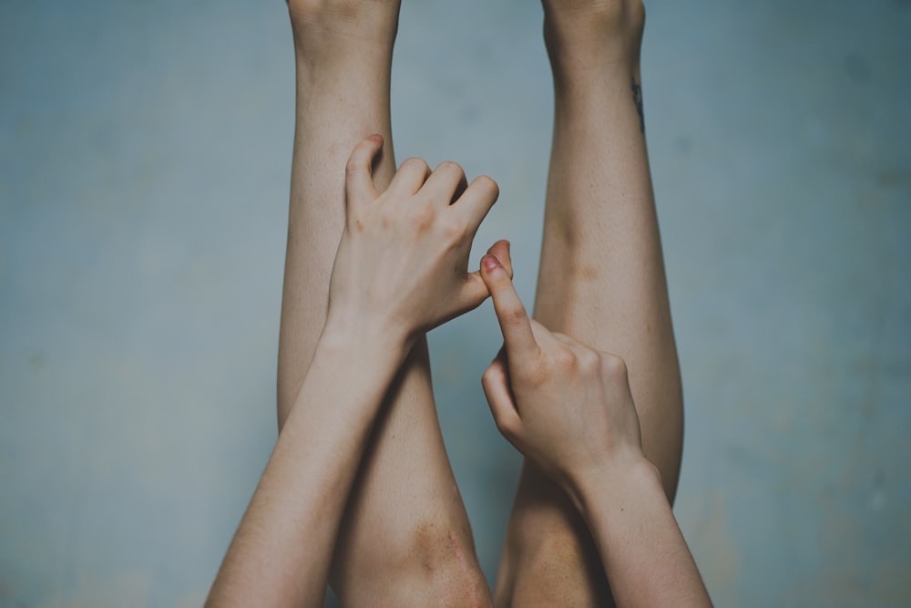 two hands reaching up towards each other