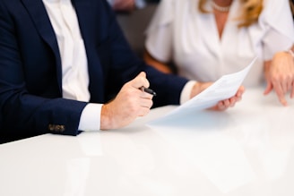 a man and a woman sitting at a white table