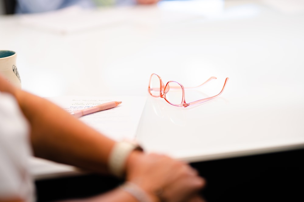 a pair of glasses sitting on top of a table