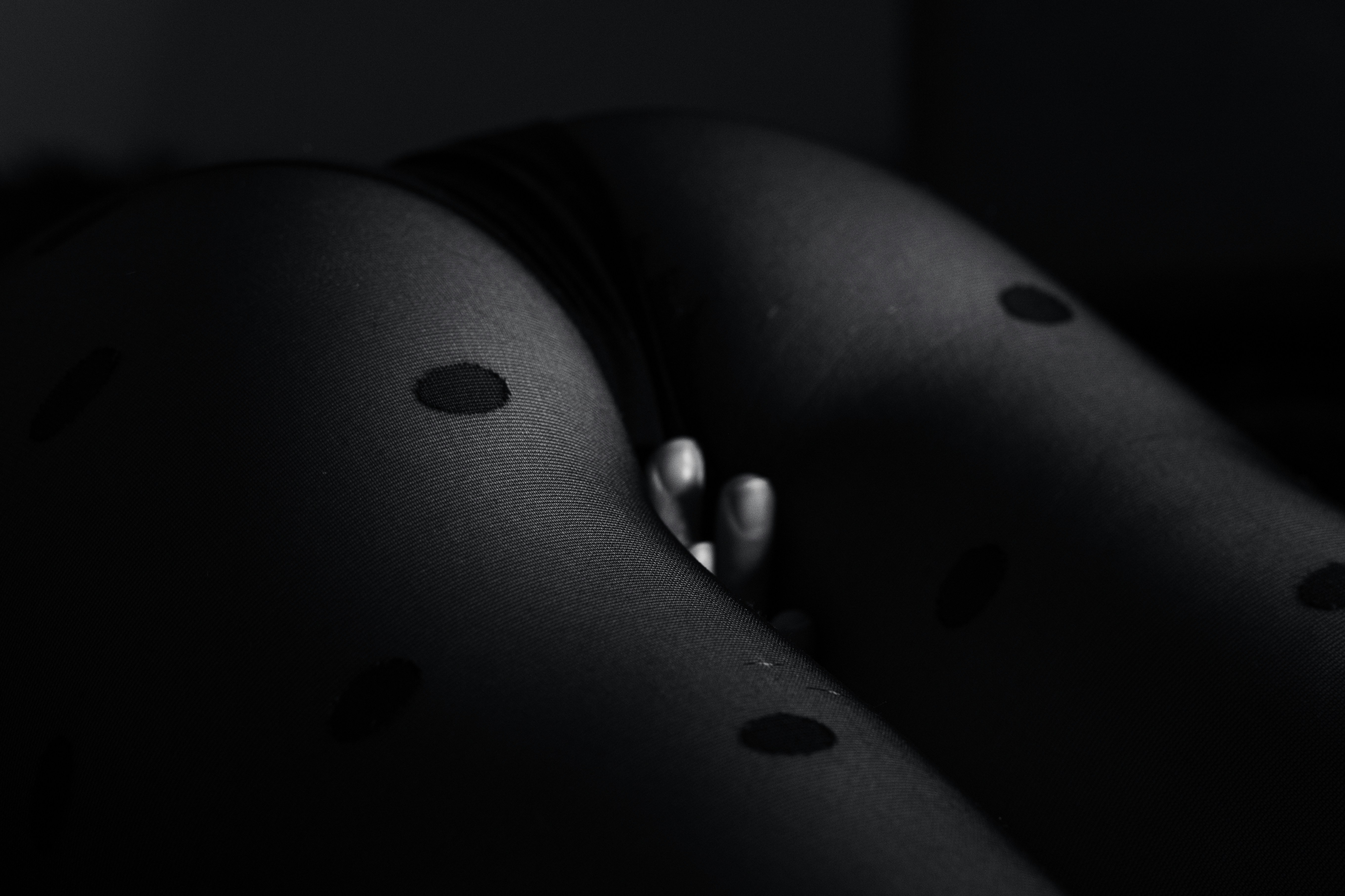 a black and white photo of a person wearing tights