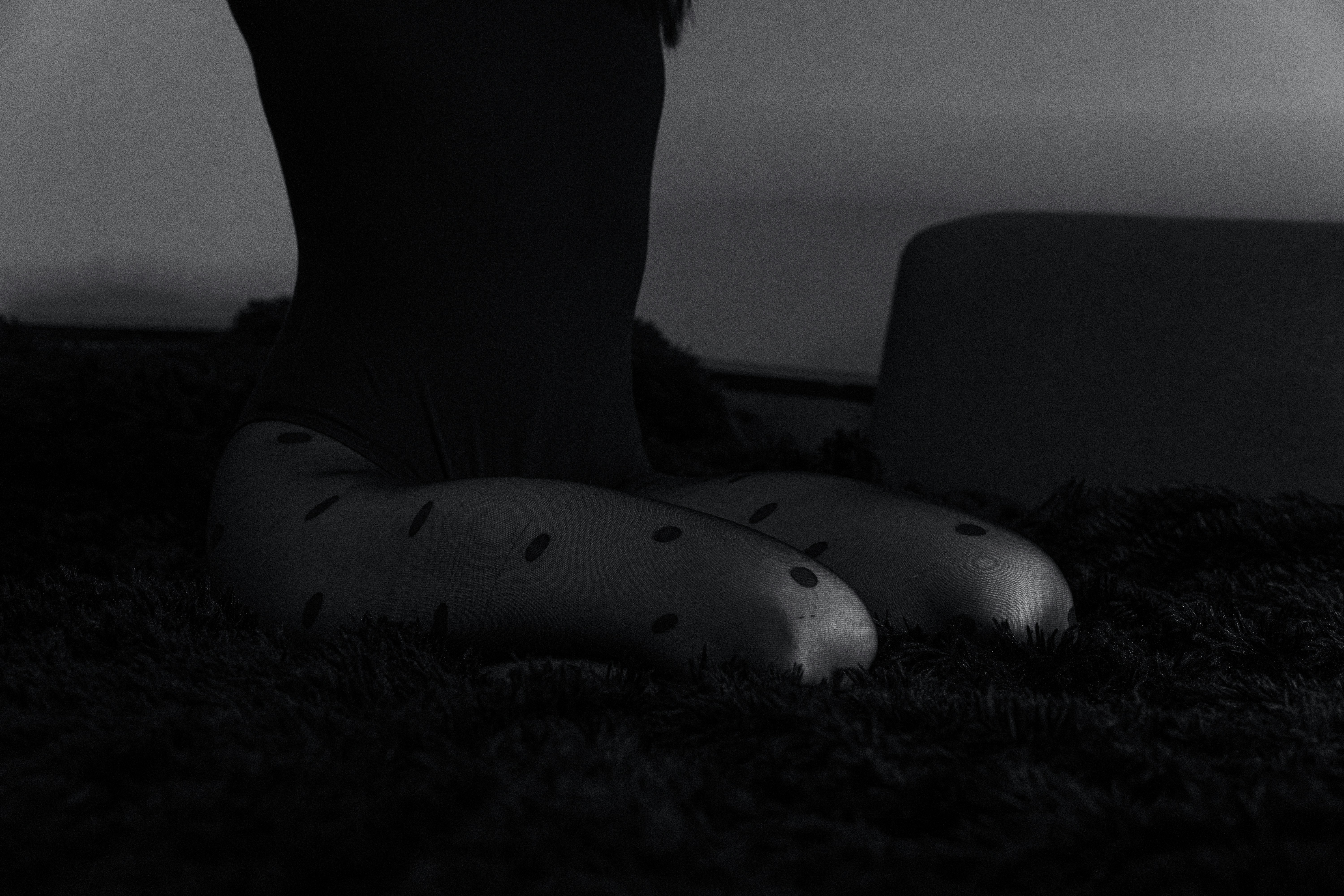 a black and white photo of a woman's legs with polka dots on them