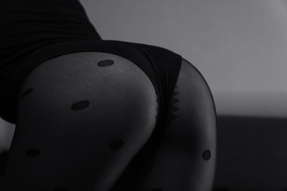 a woman's legs with black polka dots on them