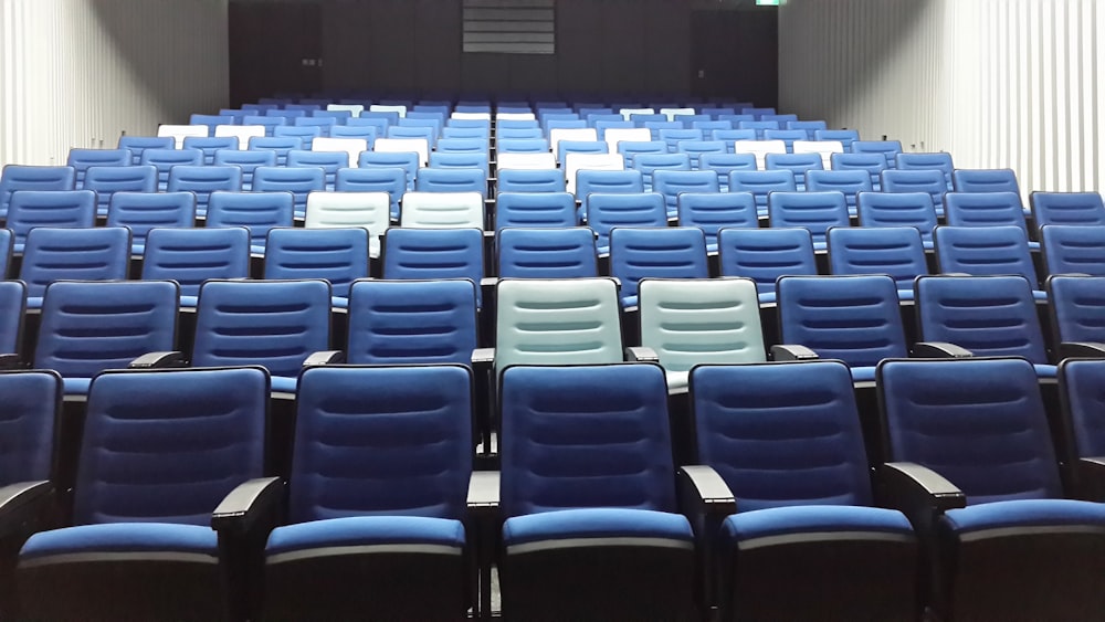 rows of blue and black chairs in a room