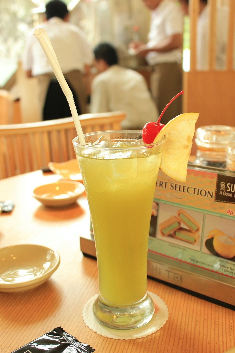 a glass filled with a drink sitting on top of a table