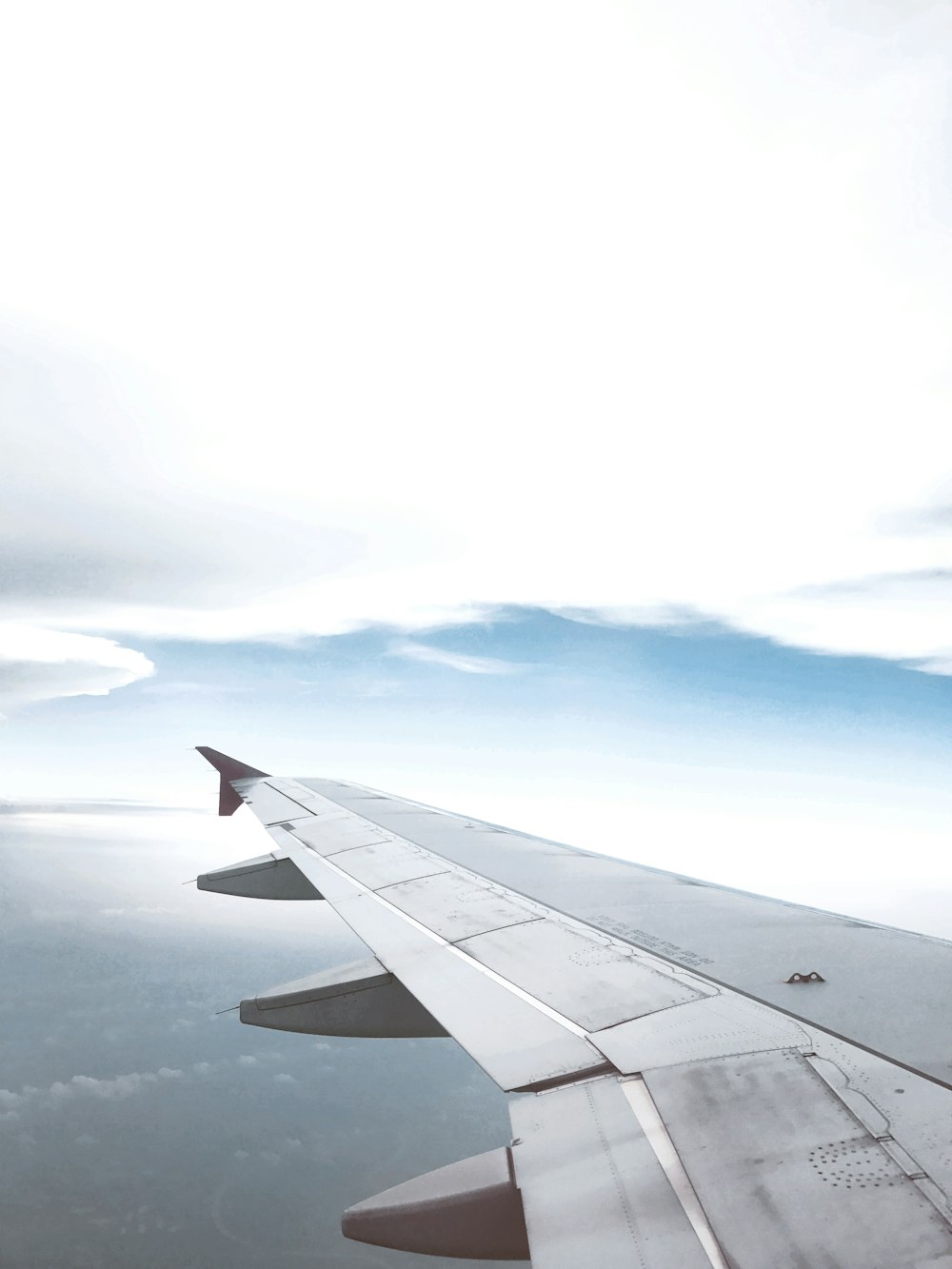 a view of the wing of an airplane in the sky