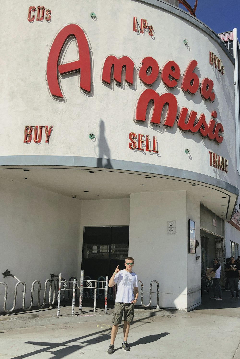 a man standing in front of a music store