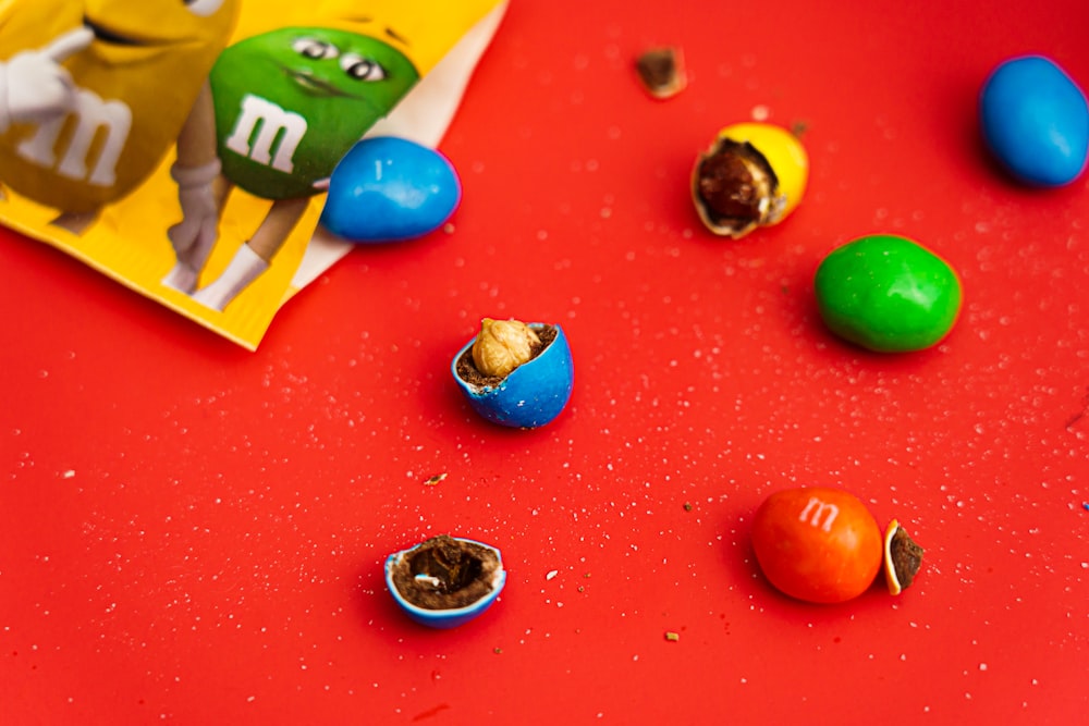 a red table topped with lots of candy