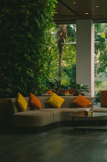a living room filled with furniture and lots of plants