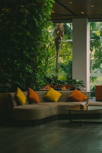 a living room filled with furniture and lots of plants