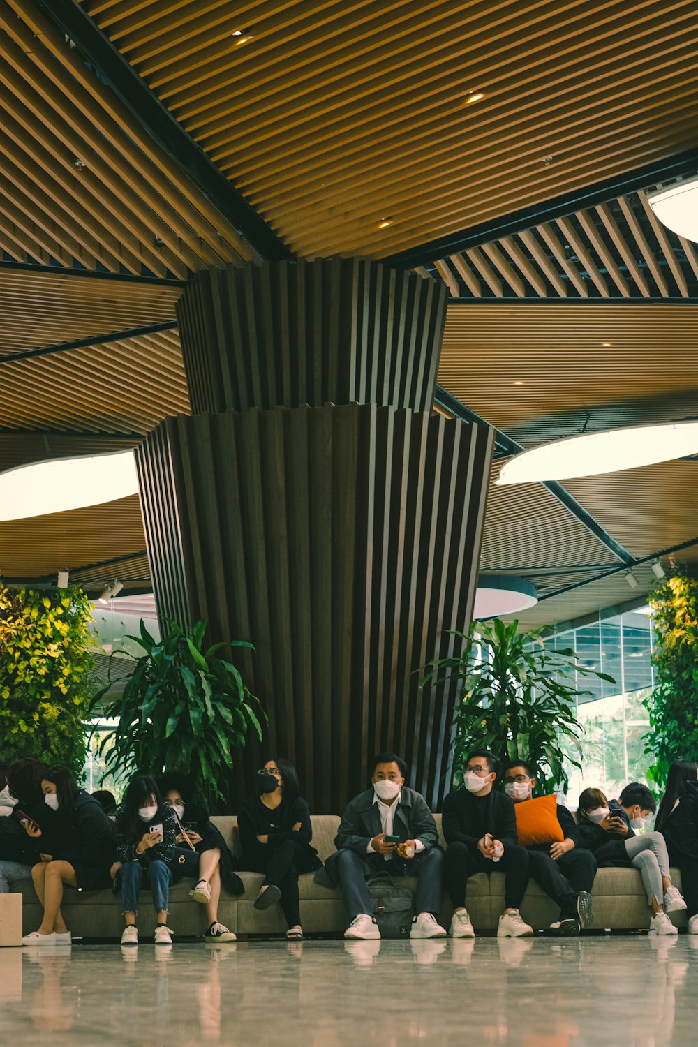 a group of people sitting on couches in a lobby