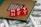 Red blocks with the letters NFT written on them are placed on a computer chip, overlaid on US dollar bills.