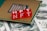 Red blocks with the letters NFT written on them are placed on a computer chip, overlaid on US dollar bills.