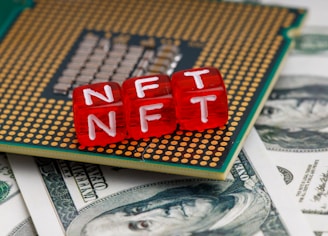 a close up of a small red block on top of a pile of money