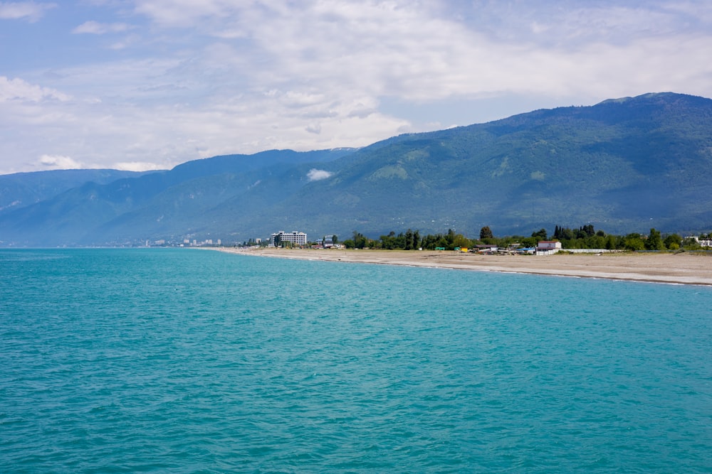 a body of water with mountains in the background