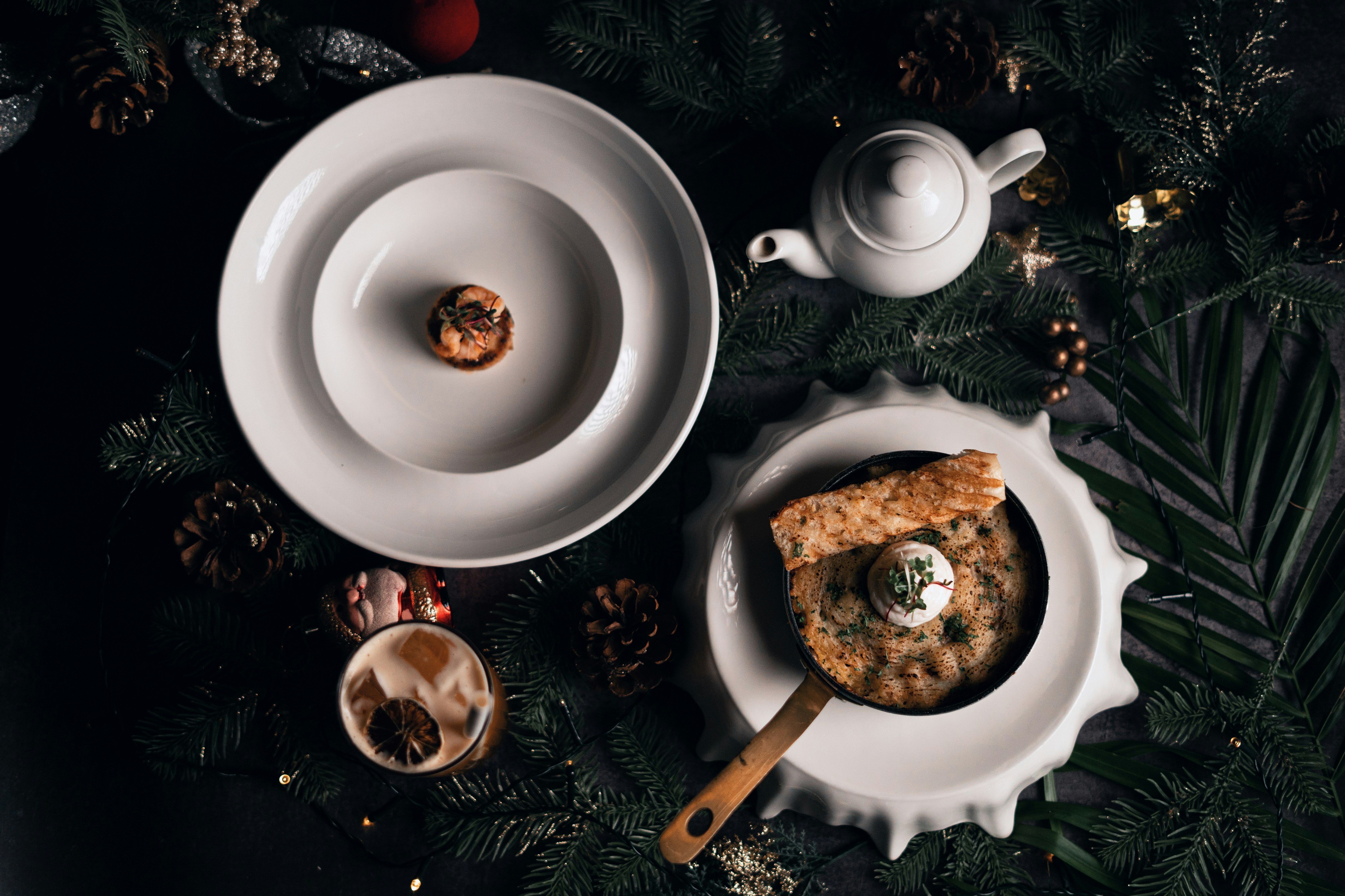 a table topped with plates and bowls filled with food