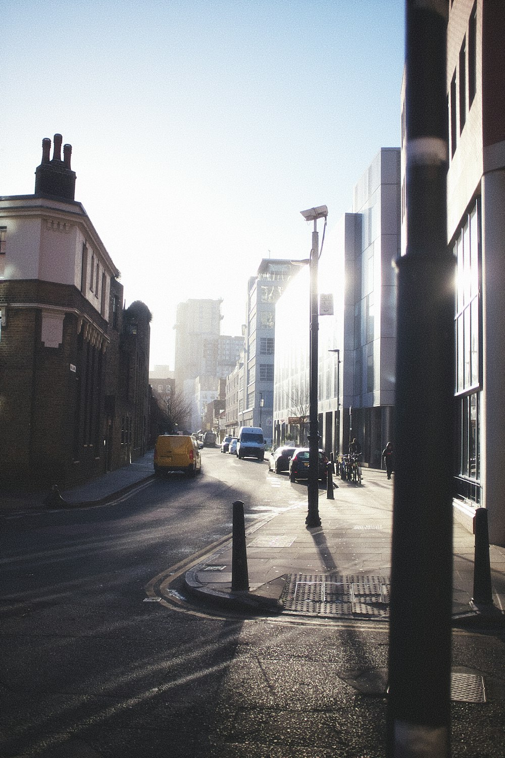 a city street with cars parked on the side of it