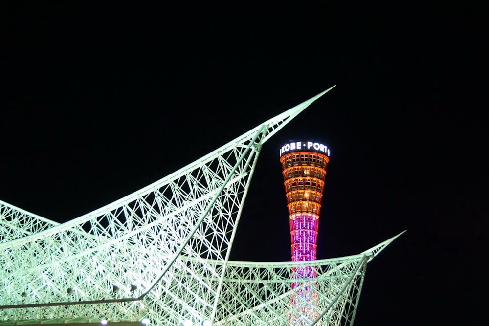 a tall tower lit up in the night sky