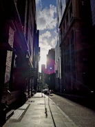 A cinematic still of a sunlit urban street captured with rich colors and dynamic shadows.