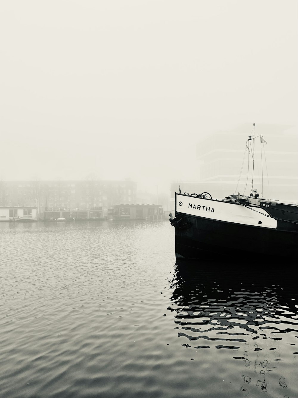 a black and white photo of a boat in the water