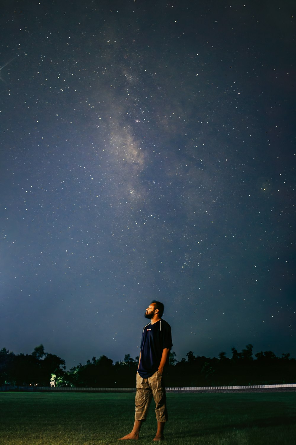 a man looking up at the stars in the sky