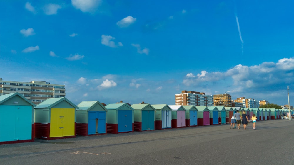 a row of colorful beach huts sitting next to each other