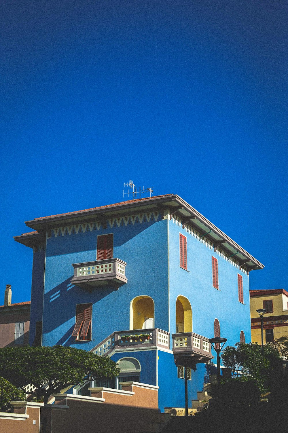 a blue building with a clock on the top of it