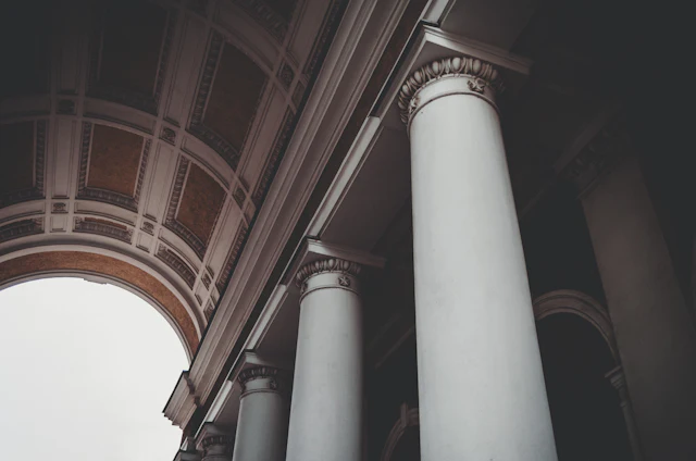A couple of white pillars in front of a building