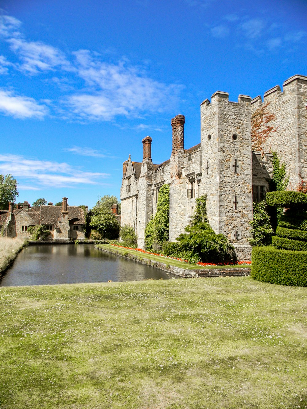 a castle with a pond in front of it