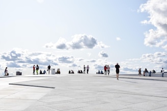 a group of people standing on top of a cement floor