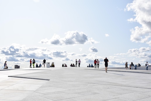 a group of people standing on top of a cement floor