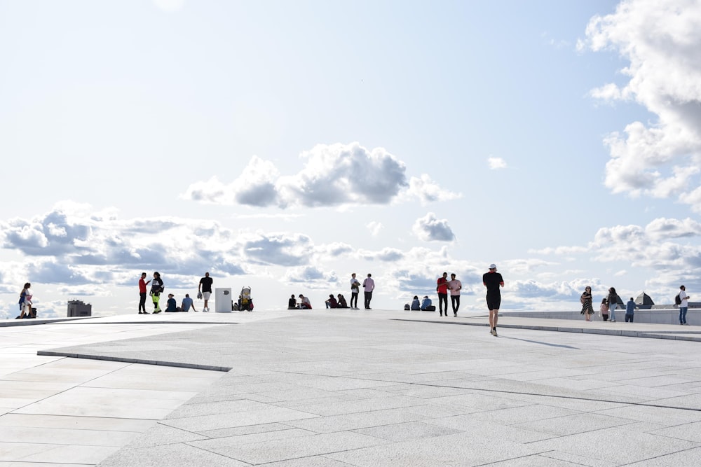 a group of people standing on top of a cement floor