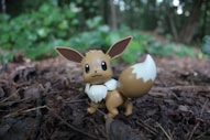 a small figurine of a pokemon sitting on the ground