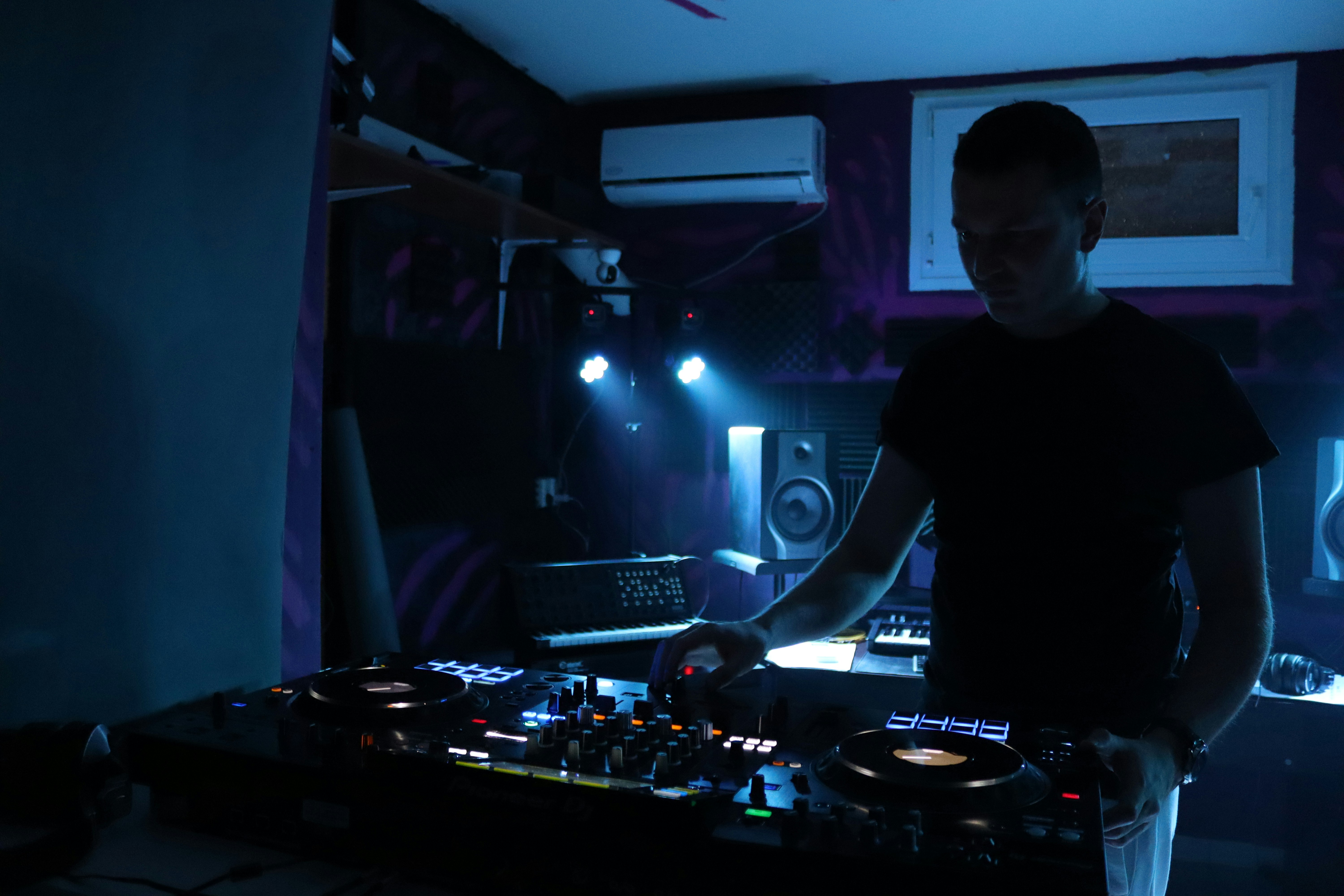 DJ mixing music in dark room