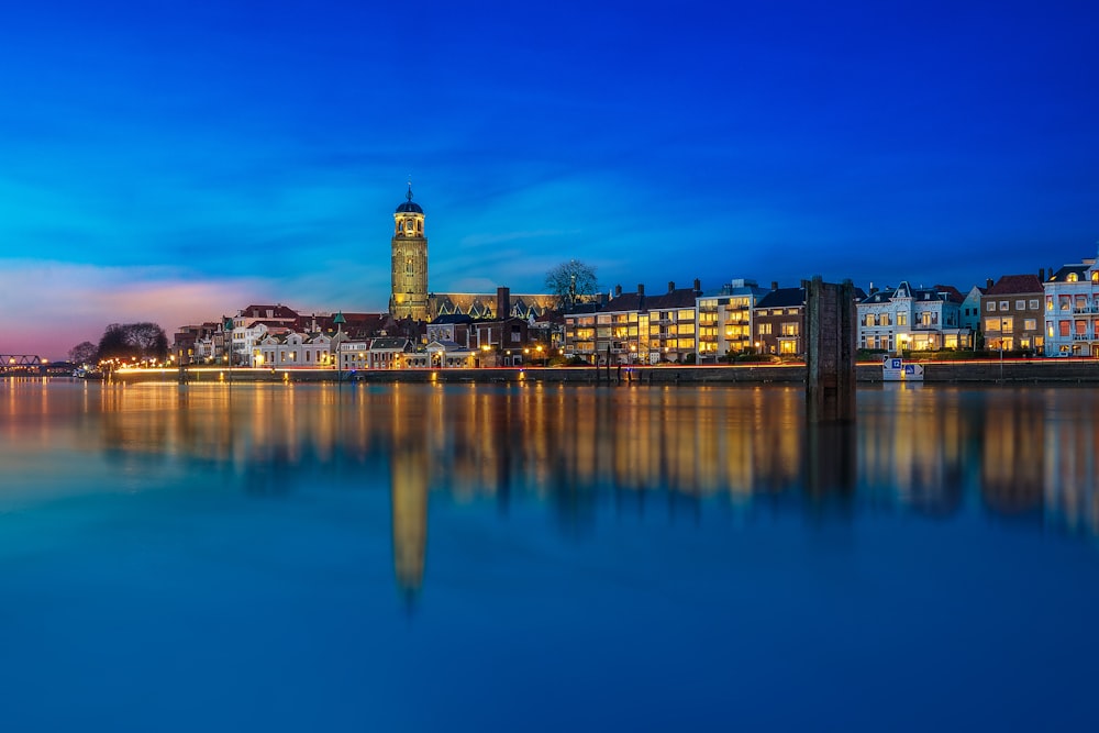 a large body of water with buildings in the background