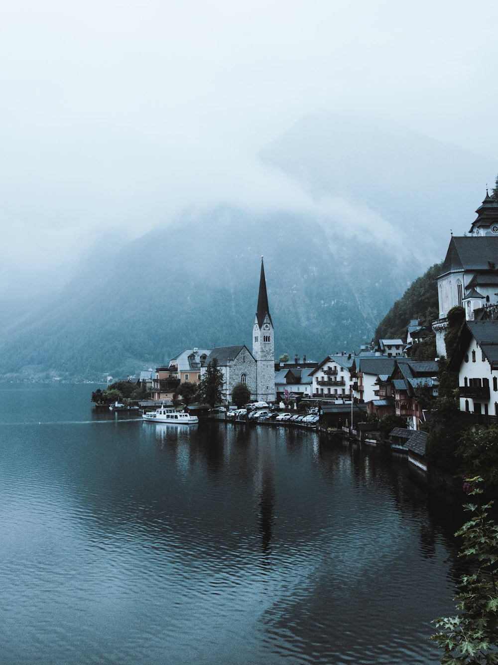 a small town on a lake surrounded by mountains