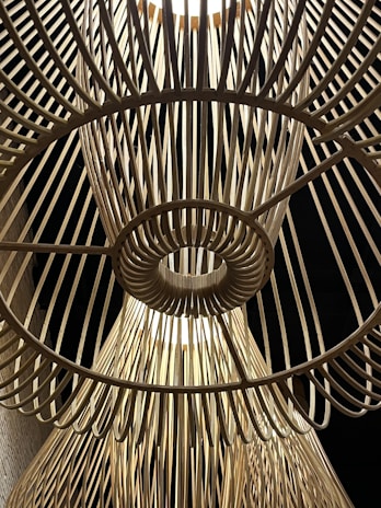 Handcrafted wooden wind spinner with intricate patterns inspired by Greek island architecture.