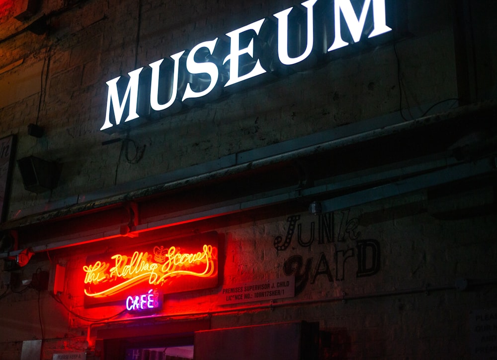 a building with a neon sign that reads museum